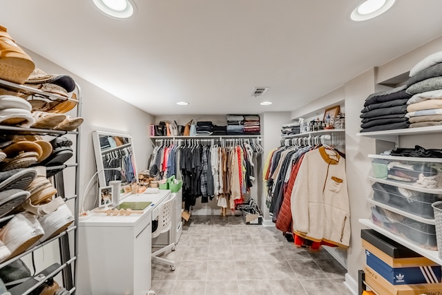 walk in closet with light tile patterned floors