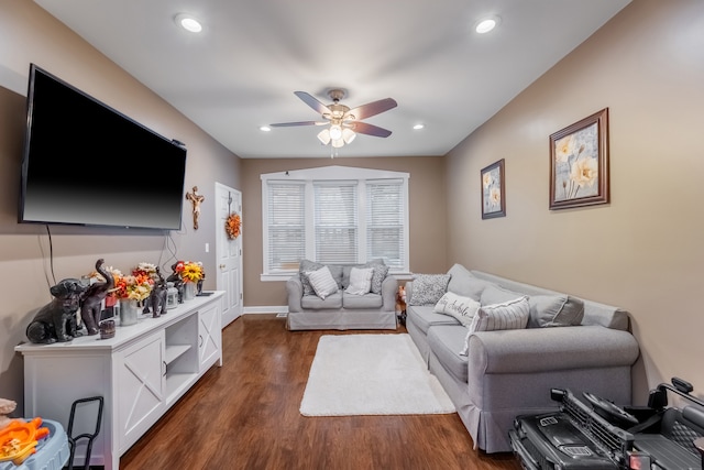 living room with ceiling fan and dark wood-type flooring