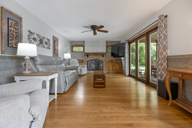 living room with a fireplace, hardwood / wood-style floors, and ceiling fan