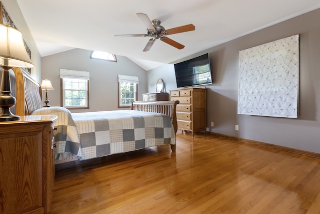 bedroom with hardwood / wood-style floors, vaulted ceiling, and ceiling fan