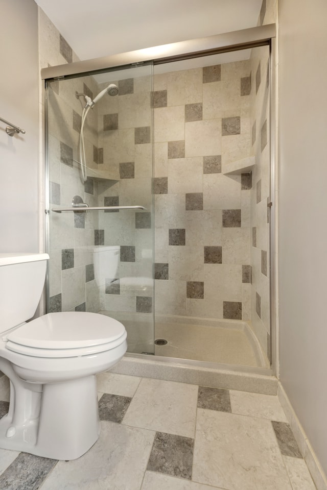 bathroom featuring toilet and walk in shower