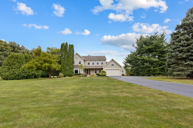 view of front of property featuring a front lawn and a garage