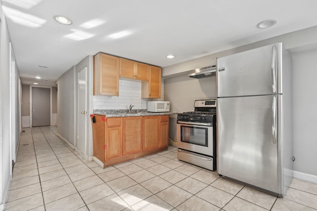 kitchen featuring exhaust hood, sink, decorative backsplash, light tile patterned floors, and stainless steel appliances