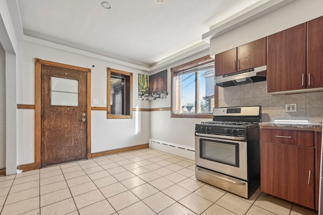 kitchen with stainless steel gas range oven, decorative backsplash, light tile patterned floors, and a baseboard heating unit