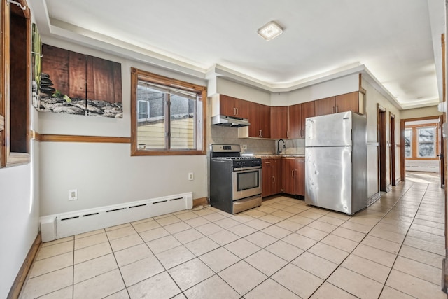 kitchen featuring backsplash, light tile patterned floors, stainless steel appliances, and a baseboard radiator