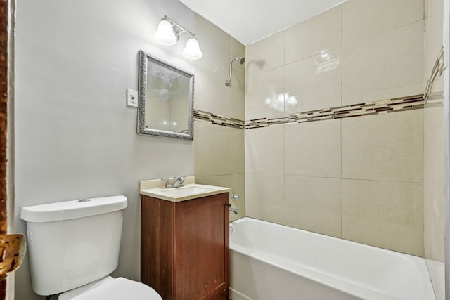 full bathroom with vanity, toilet, and tiled shower / bath