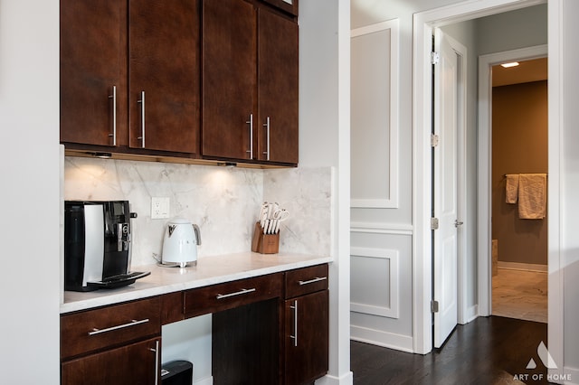 kitchen with dark brown cabinets, backsplash, and dark hardwood / wood-style floors