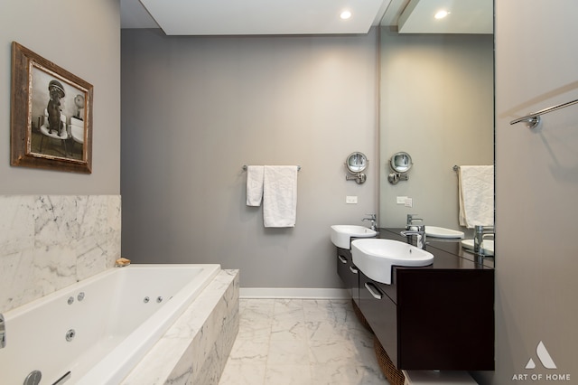 bathroom with vanity and a relaxing tiled tub