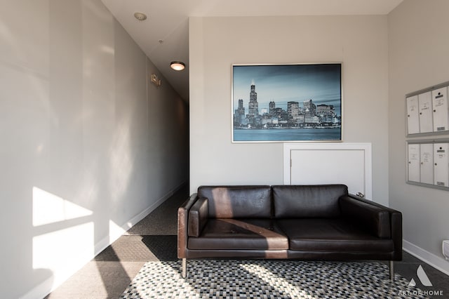 living room featuring carpet and a mail area