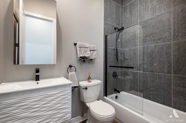 full bathroom with combined bath / shower with glass door, vanity, and toilet