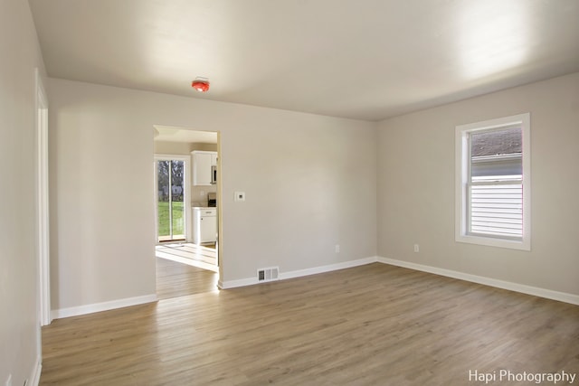 unfurnished room featuring hardwood / wood-style flooring