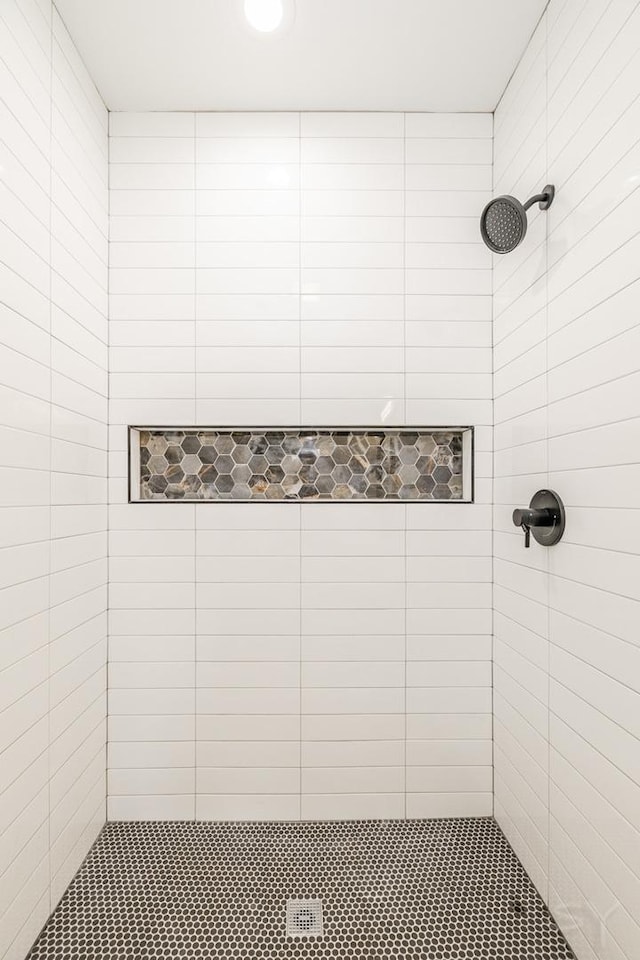 bathroom with a tile shower