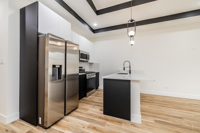 kitchen with sink, white cabinets, stainless steel appliances, and light hardwood / wood-style floors