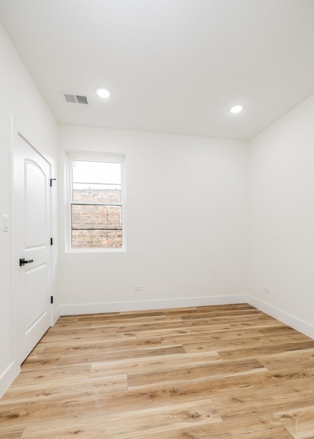 unfurnished room with light hardwood / wood-style floors