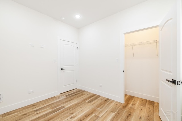 interior space with light hardwood / wood-style floors, a spacious closet, and a closet