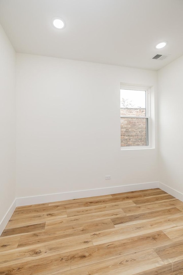 spare room featuring light hardwood / wood-style flooring