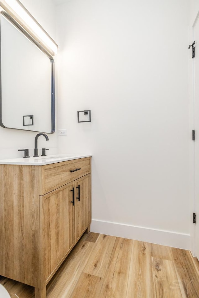 bathroom featuring vanity and wood-type flooring