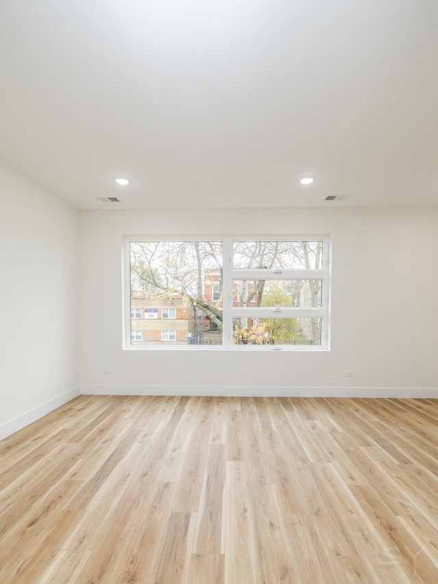 unfurnished room with light hardwood / wood-style floors