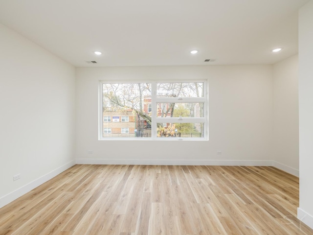 spare room featuring light hardwood / wood-style floors