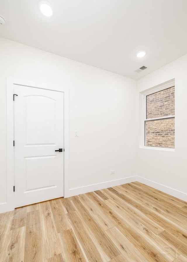 spare room featuring hardwood / wood-style flooring