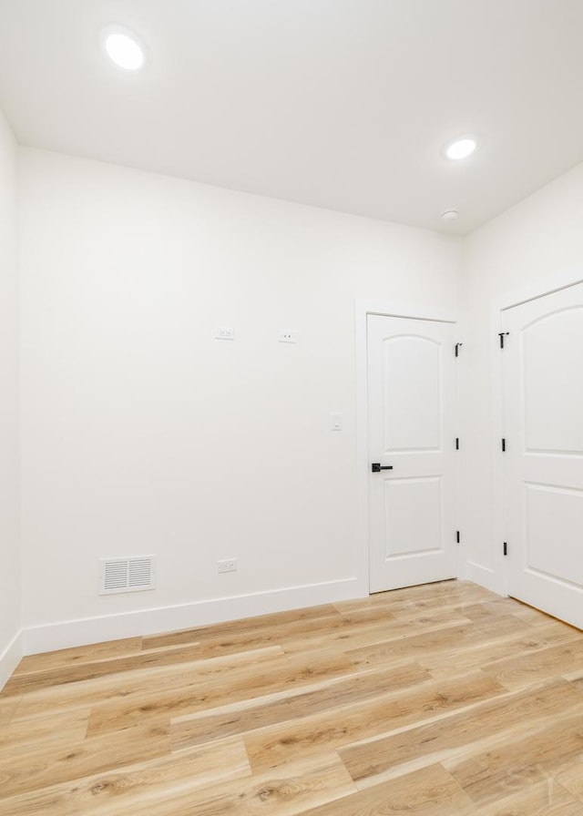 spare room featuring light hardwood / wood-style floors