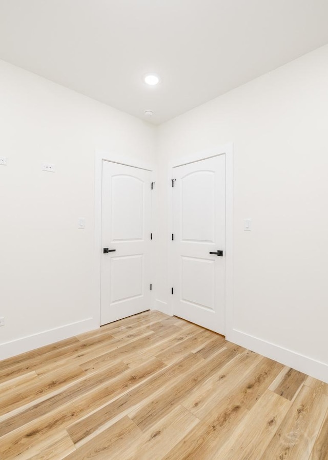 empty room with hardwood / wood-style flooring