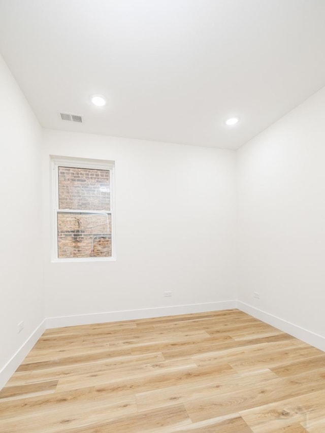 spare room featuring light hardwood / wood-style floors