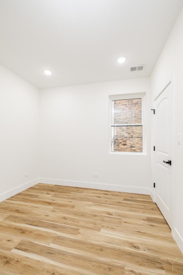 spare room with light wood-type flooring