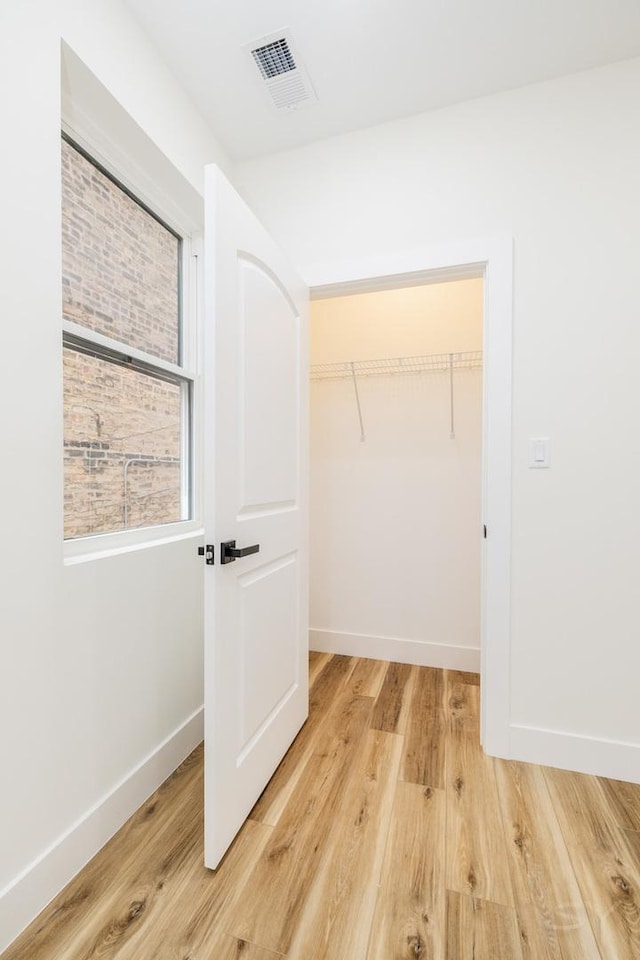 walk in closet featuring hardwood / wood-style flooring