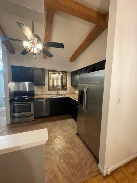 kitchen featuring ceiling fan, sink, stainless steel appliances, lofted ceiling with beams, and backsplash