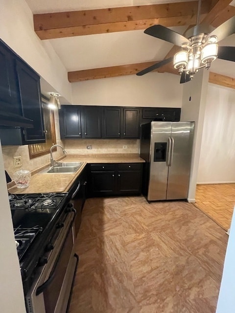 kitchen with backsplash, lofted ceiling with beams, sink, ceiling fan, and appliances with stainless steel finishes