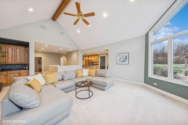 carpeted living room featuring beamed ceiling, ceiling fan, and high vaulted ceiling