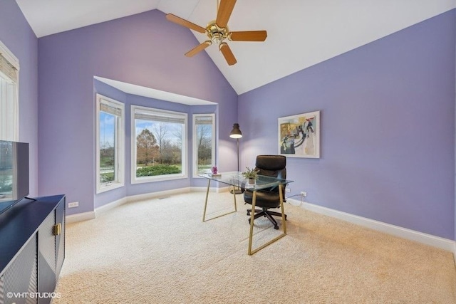 carpeted office space with ceiling fan and high vaulted ceiling