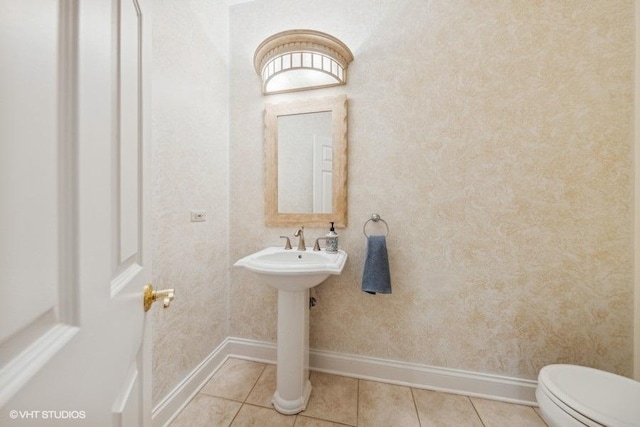 bathroom with tile patterned flooring, toilet, and sink