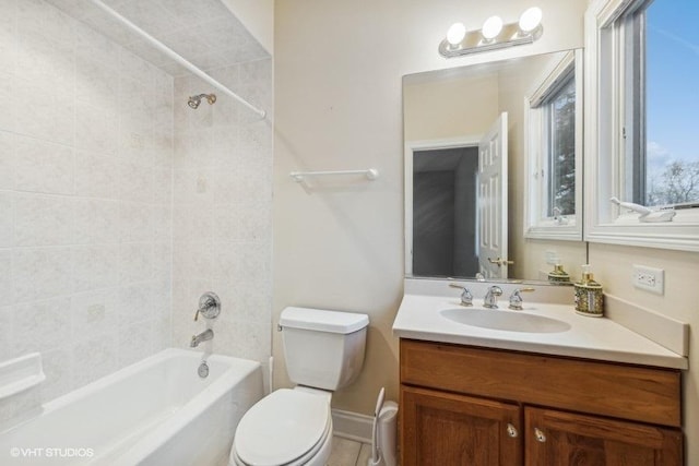 full bathroom featuring toilet, vanity, and tiled shower / bath