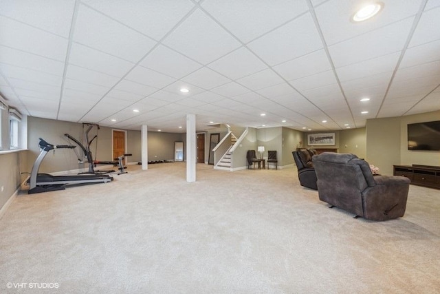 carpeted living room with a paneled ceiling