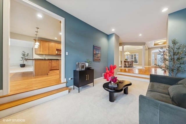 living room with light hardwood / wood-style flooring and a chandelier