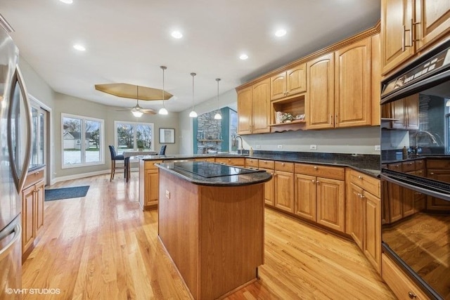 kitchen featuring pendant lighting, light wood-type flooring, stainless steel refrigerator, and ceiling fan