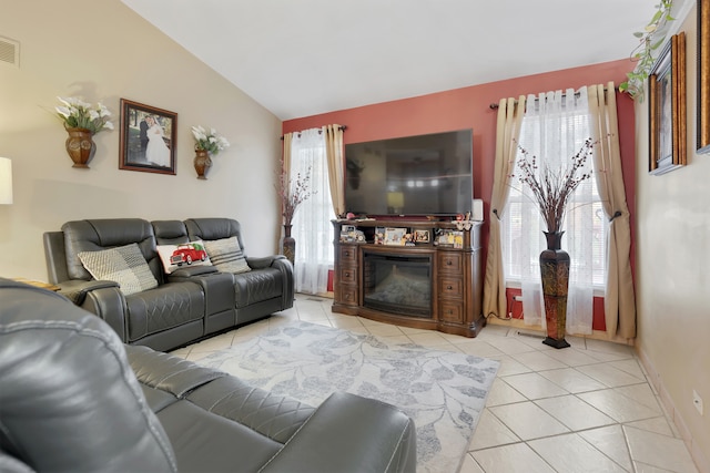 living room featuring light tile patterned flooring and vaulted ceiling