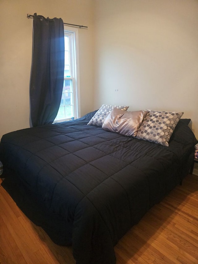 bedroom with hardwood / wood-style floors