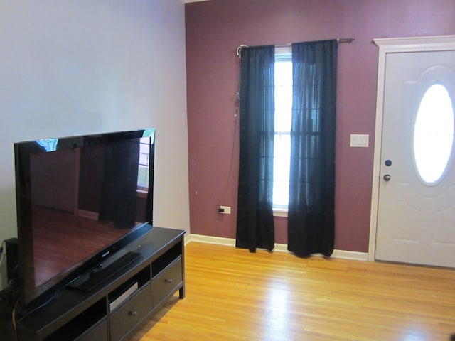 living room with light hardwood / wood-style floors and ornamental molding