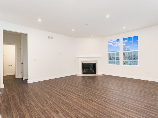 unfurnished living room featuring dark wood-type flooring