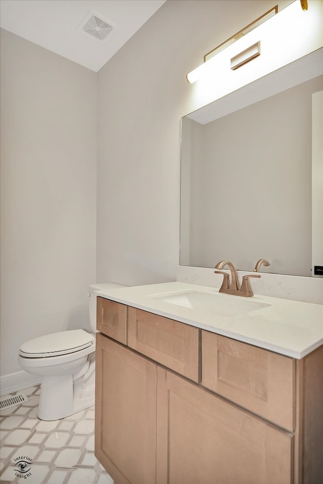 bathroom with vanity and toilet