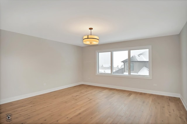 unfurnished room with light wood-type flooring