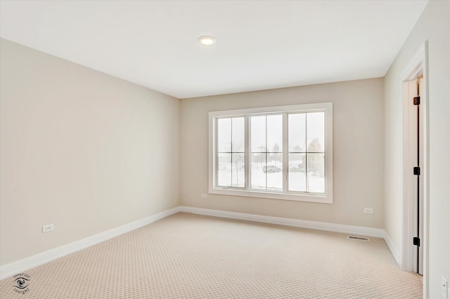 unfurnished room with light carpet