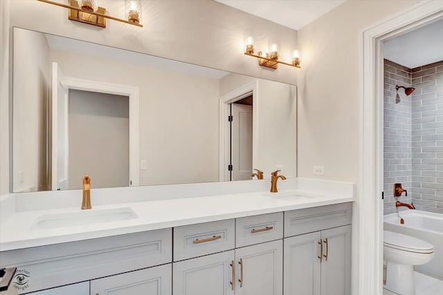 full bathroom with toilet, vanity, and tiled shower / bath combo