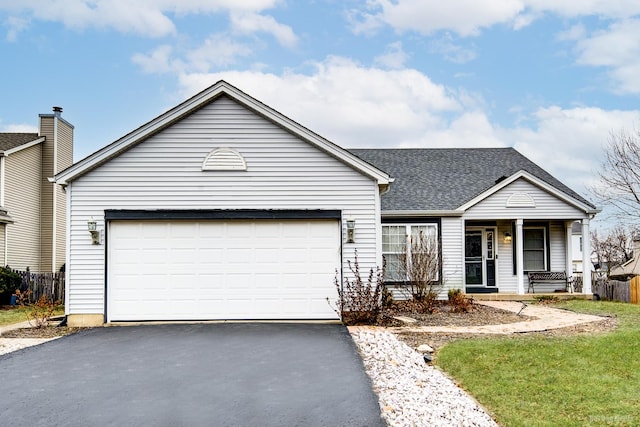 ranch-style home with a porch and a garage