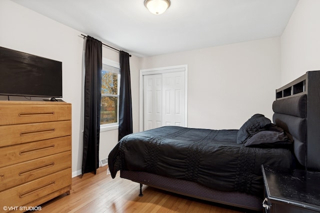 bedroom with a closet and hardwood / wood-style flooring