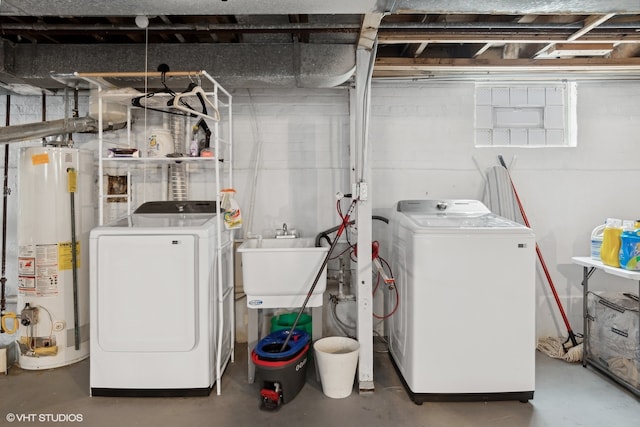 laundry area featuring washer and dryer, sink, and water heater