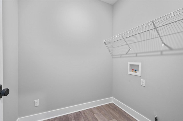 clothes washing area featuring washer hookup and hardwood / wood-style floors